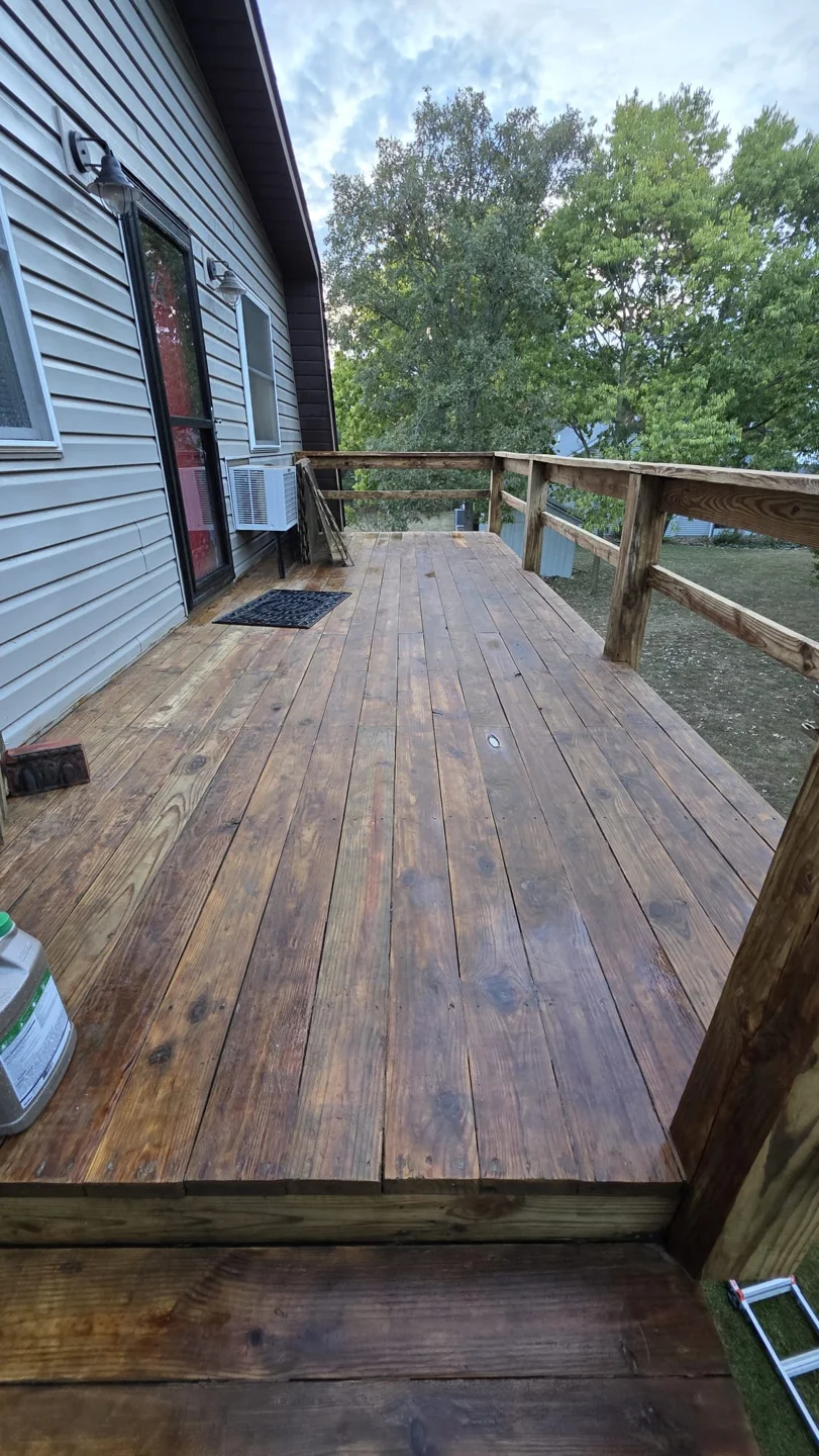 Wood deck and railing beside a house