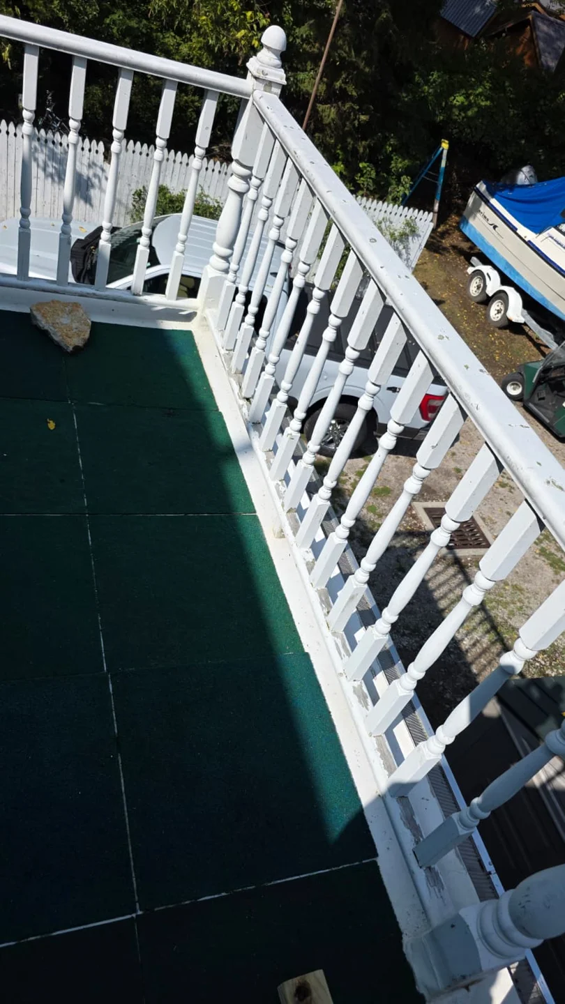 White railing beside a deck
